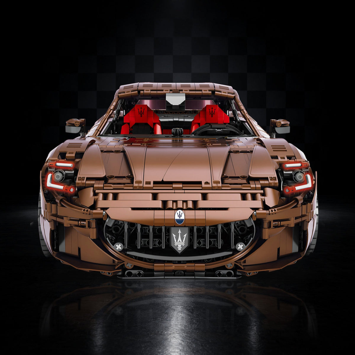 Bronze Edition Maserati GranTurismo brick model, front view under a studio spotlight