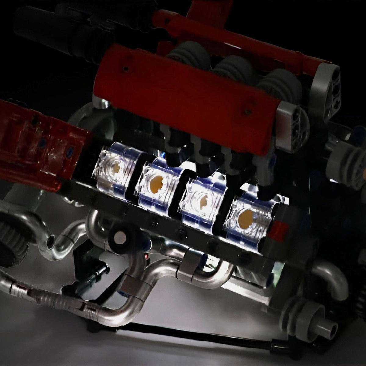 Transparent cylinder blocks of the Motorised V8 Engine lit by its LED module