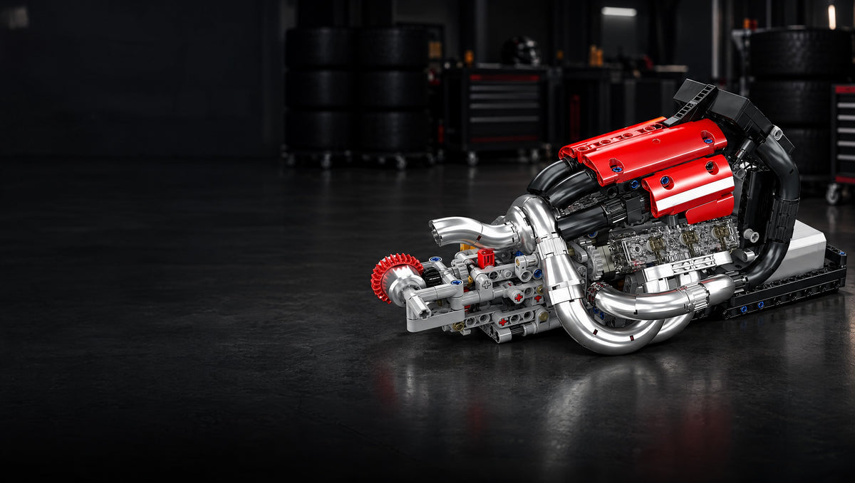 Pistons turning beneath red cam covers