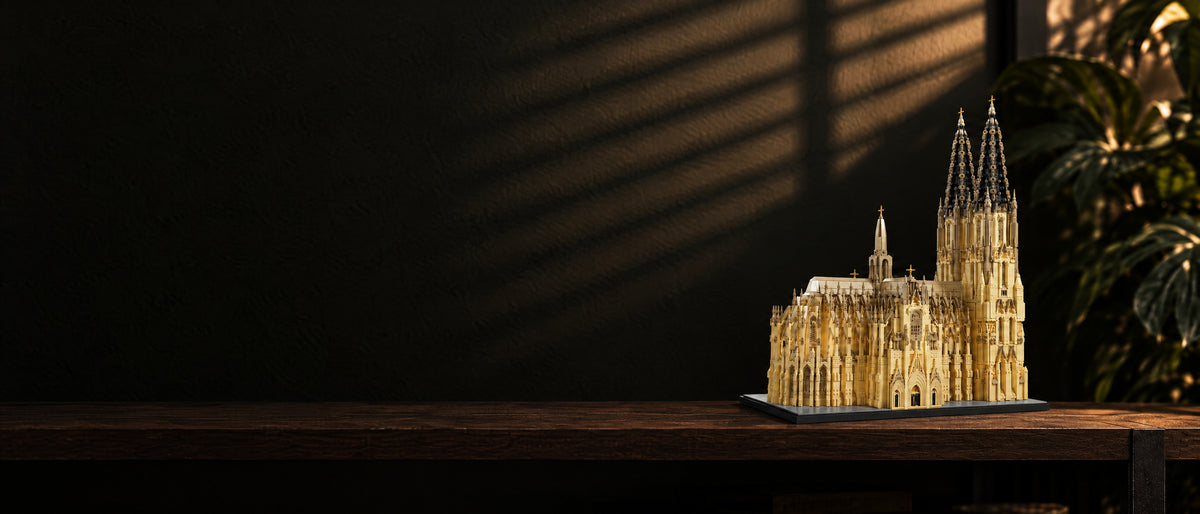 Cologne Cathedral brick model on a dark wooden shelf